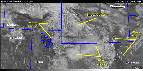 vis image over the central Rocky Mountains with annotations showing low clouds and snow cover